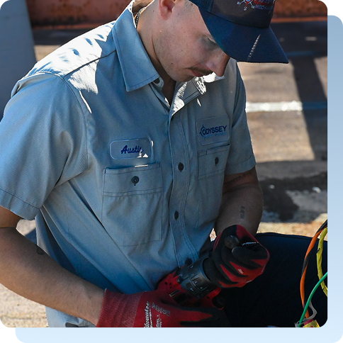 Technician repairing a commercial AC unit